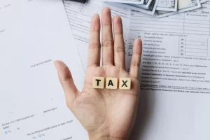 Tax Words On Palm Hands Against The Tax Forms 2023 03 30 19 42 03 Utc Scaled - Thargo Contabilidade
