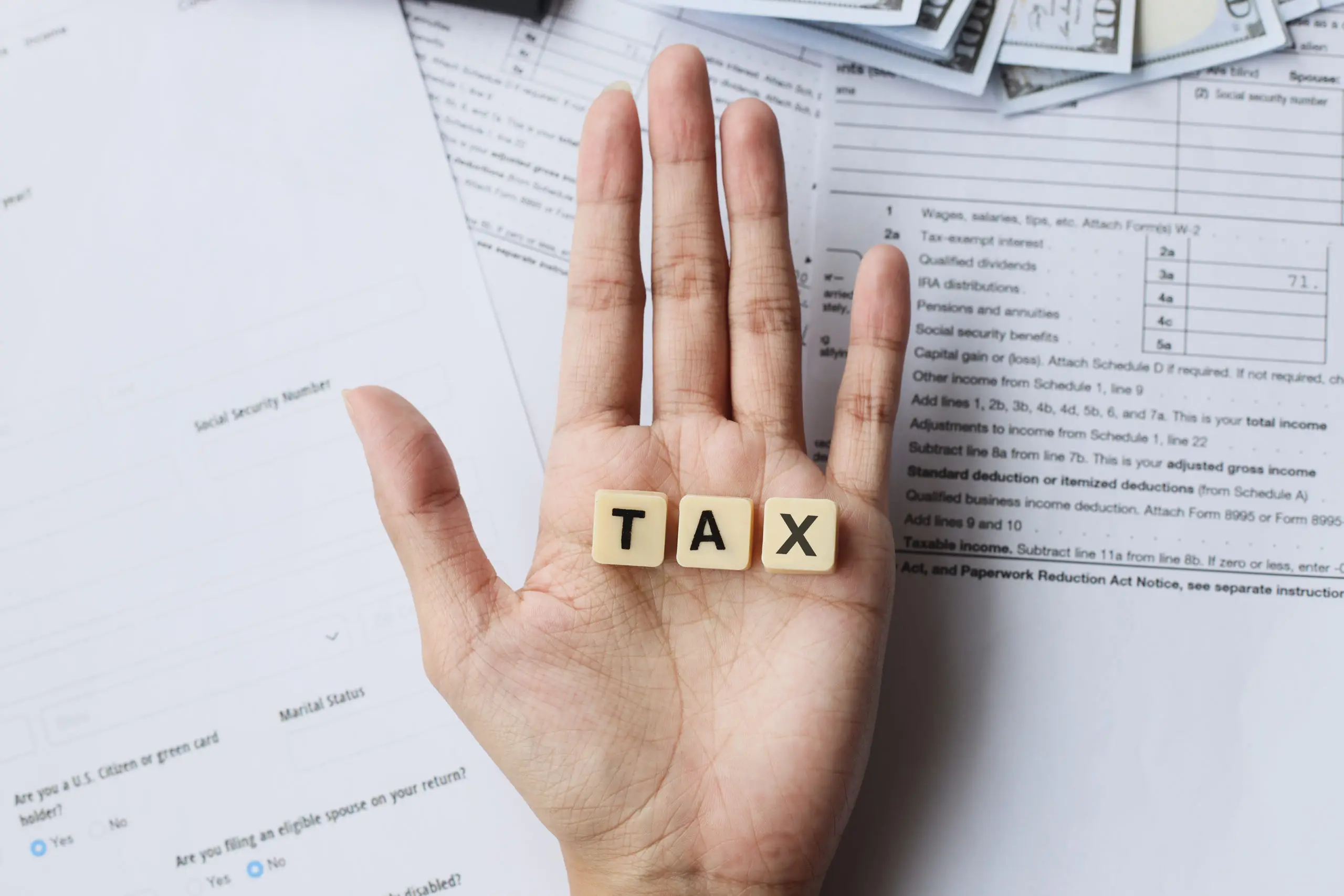 Tax Words On Palm Hands Against The Tax Forms 2023 03 30 19 42 03 Utc Scaled - Thargo Contabilidade